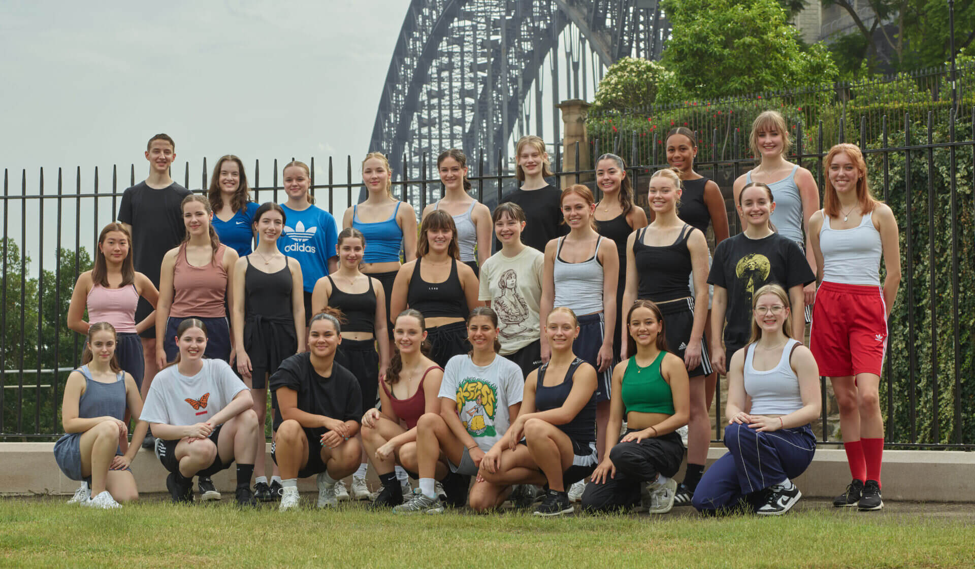 Sydney Dance Company's Pre-Professional Year 1 cohort standing in a group with the Sydney Harbour Bridge in the background.